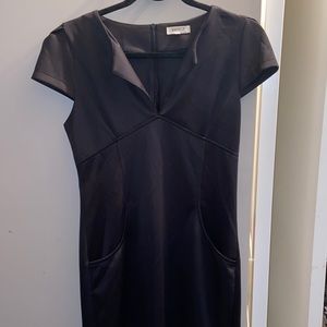 Little black dress with pockets and small v neck in size Medium and mid length